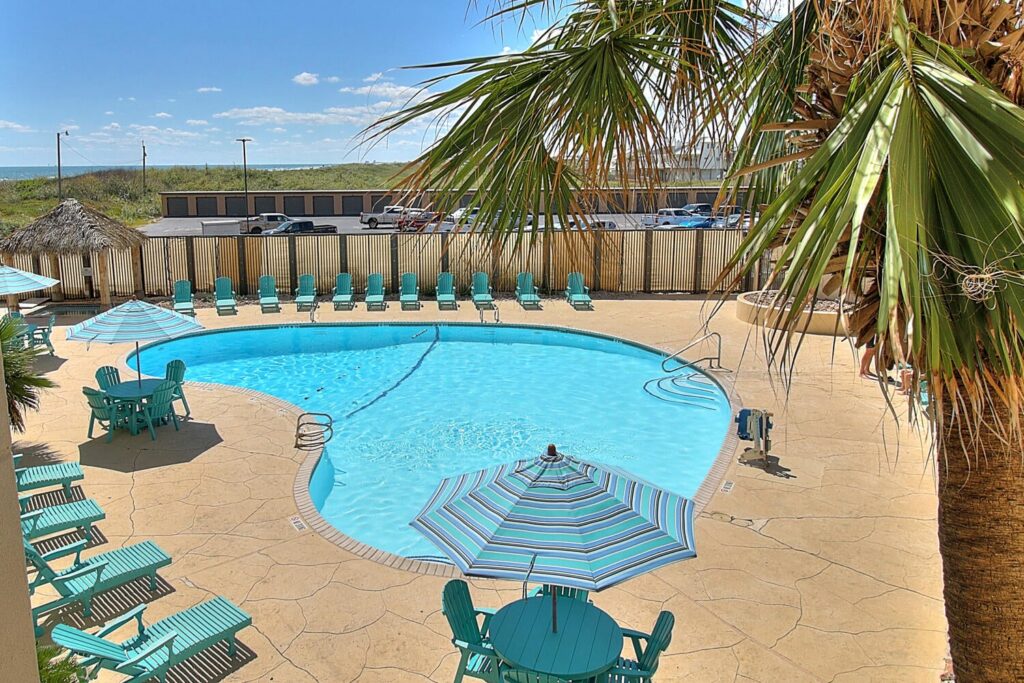 a view of the pool at The Dunes Condominiums